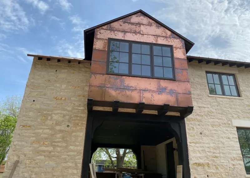 Copper metal panel facade on a stone building for Skylight Installation in Forestville
